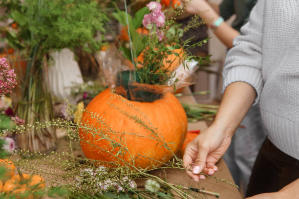 istock Creating a floral composition in a pumpkin. Making decor with your own hands. 2194297643