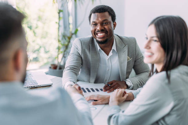 istock Businesspeople shaking hands across the table. 2194299663