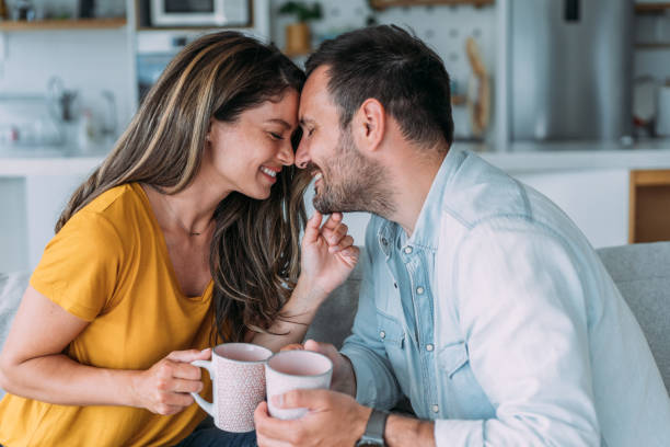 istock Lovely young couple drinking coffee at home. 2194299691
