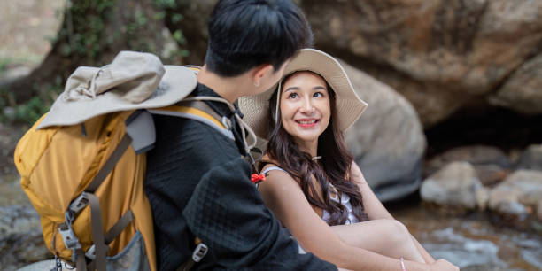 istock LGBT couple enjoying a playful conversation by a serene stream during their hike 2194300447