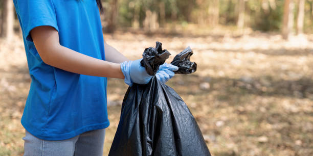 istock Volunteer holding a garbage bag in a forest, showcasing commitment to environmental cleanup and community service 2194300689