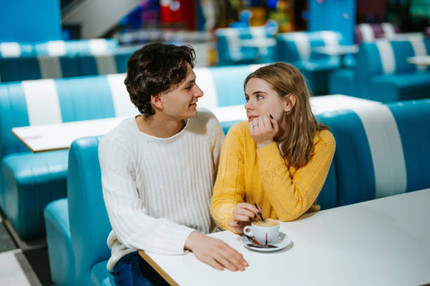istock Young couple enjoying coffee in a cozy cafe during a casual outing 2194301122