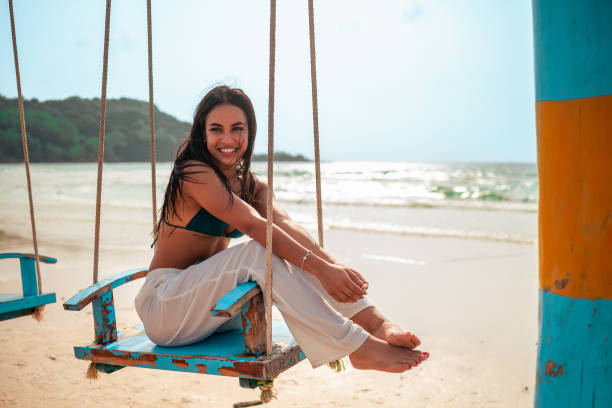 istock Relaxed Hispanic Woman on Beach Swing 2194301434