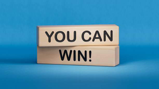 istock YOU CAN WIN! symbol. Wooden cube blocks.Copy space.3D rendering on blue background. 2194302637