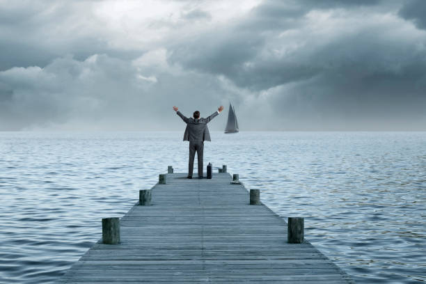 istock Man Stranded Tries To Get Attention Of Ship That Has Sailed 2194302722