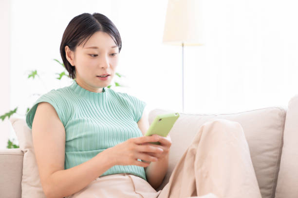 istock Asian woman using a smart phone 2194302763