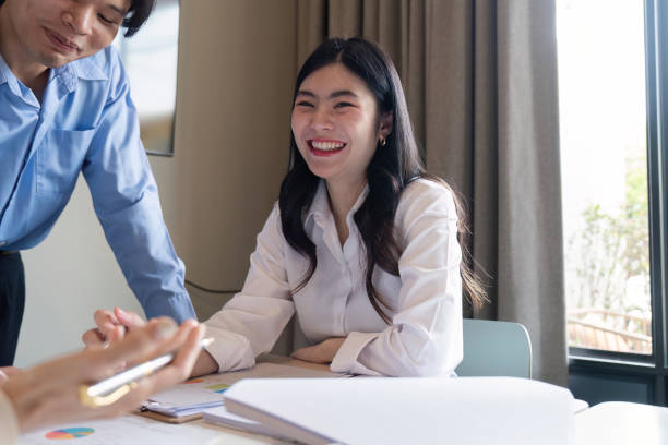 istock Smiling female professional engaged in a collaborative meeting with diverse colleagues in modern office 2194303814