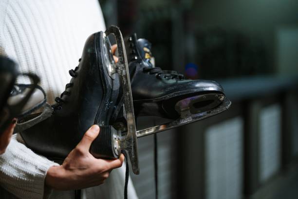 istock Skater preparing ice skates after practice at the rink in evening 2194304231