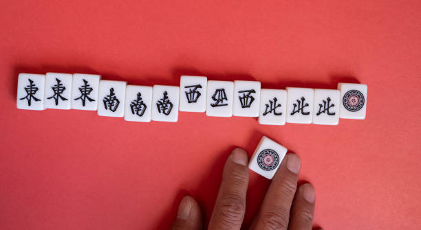 istock Mahjong tiles lined up on a red background 2194306018