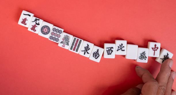 istock Mahjong tiles lined up on a red background 2194306021