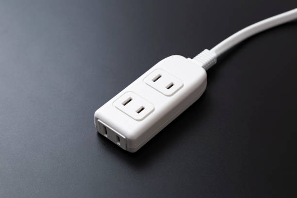 istock A three-outlet power strip on a black background. 2194309816