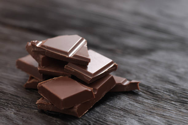 istock Broken dark chocolate on a wooden table 2194311336