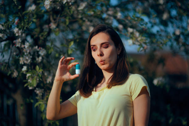 istock Surprised Woman Holding a Big Pill During Springtime 2194312190