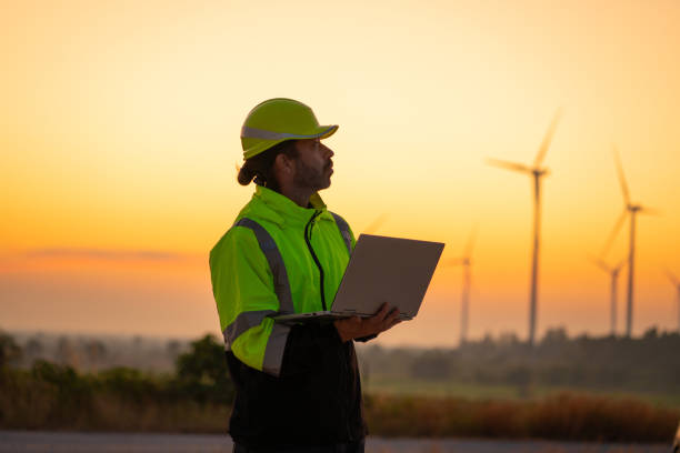 istock Engineer with laptop survey work in wind turbine farms rotation 2194316804
