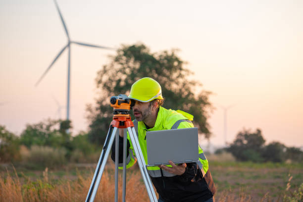 istock Engineer with laptop survey work in wind turbine farms 2194316861