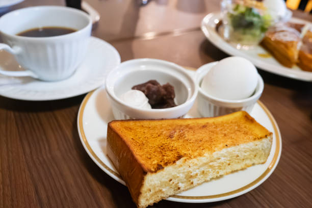 istock Breakfast at a cafe.A plate of toasted bread, boiled eggs, and sweet bean paste. 2194317378