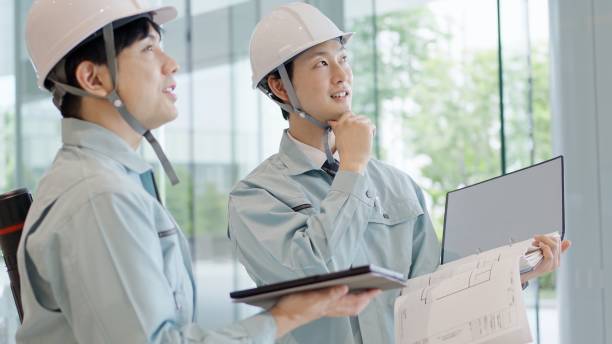 A man in work clothes having a meeting stock photo