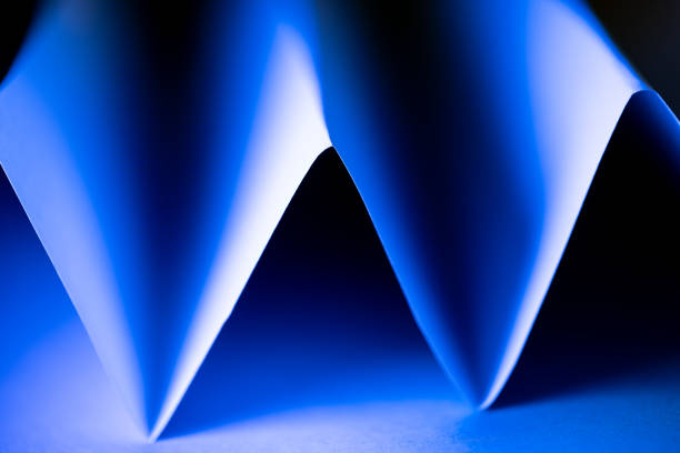 Curved shapes in vibrant blue tints and black blend together harmoniously, creating an engaging abstract composition that invites the viewer to explore textures and colors.