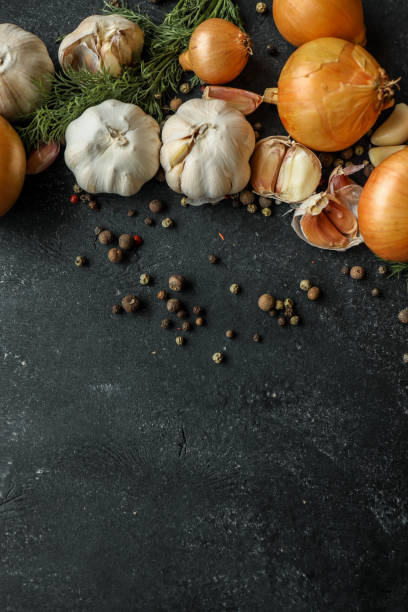 istock Fresh onions, garlic, dill, and peppercorns arranged on a dark rustic background. Perfect for culinary concepts, food styling, or showcasing organic ingredients 2194325383