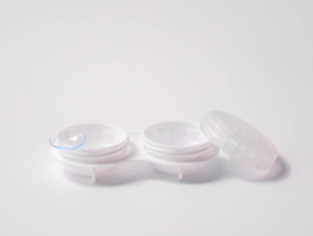 istock White contact lens case with a transparent lens on one side, placed on a clean white background. Minimalist design representing vision correction, hygiene, and eye care essentials 2194325472