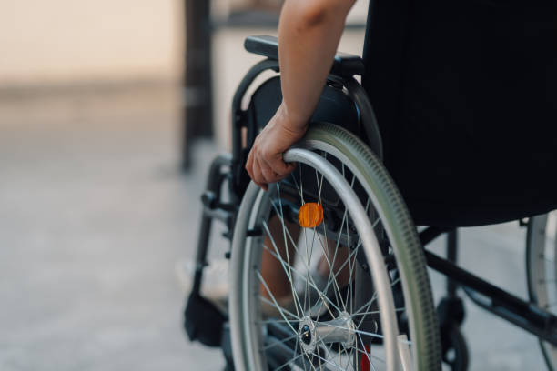 istock Patient using wheelchair moving in hospital courtyard 2194326293