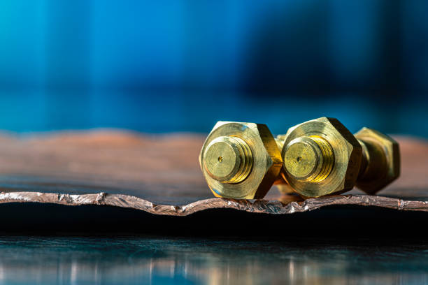 Close-up of bolts on a metal surface with industrial tonned background