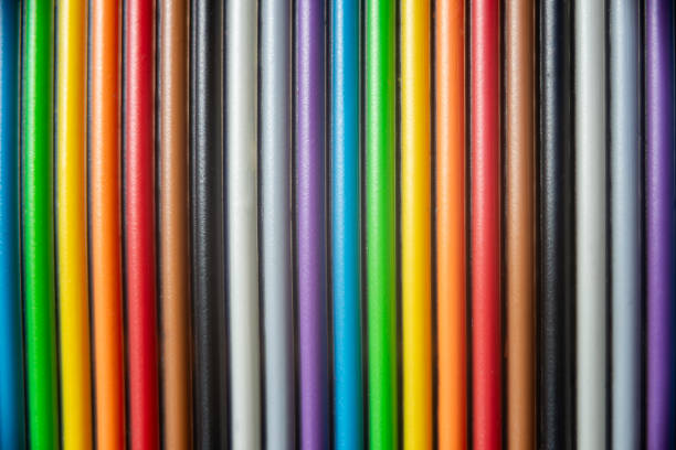 Multiple flat cables are organized vertically, displaying a vibrant array of colors and showcasing their use in technology.