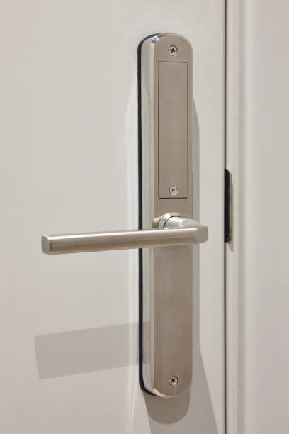 istock Metallic door handle on a white door. Hotel room interior 2194331505