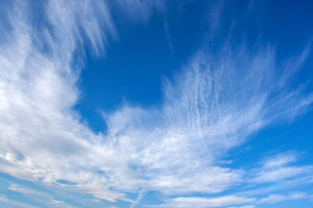 istock Cirrus clouds forming an interesting shape in a blue sky, natural background 2194333621