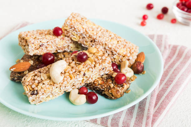 istock Various granola bars on table background. Cereal granola bars. Superfood breakfast bars with oats, nuts and berries, close up. Superfood concept 2194334747