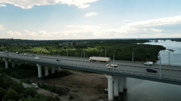 Long distance truck freight. Big lorry cargo transportation drone view from above. Large van drive city street highway. Road way logistic. Fast heavy semi trucks goods delivery. Trucker driver move.