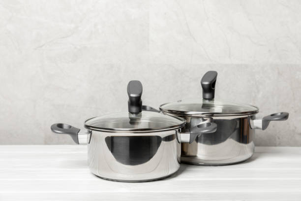 istock Stainless steel saucepan on light kitchen background. Modern saucepan. Kitchenware. Cooking pot. Cooking concept. Mockup. Space for text. Copy space. 2194335892