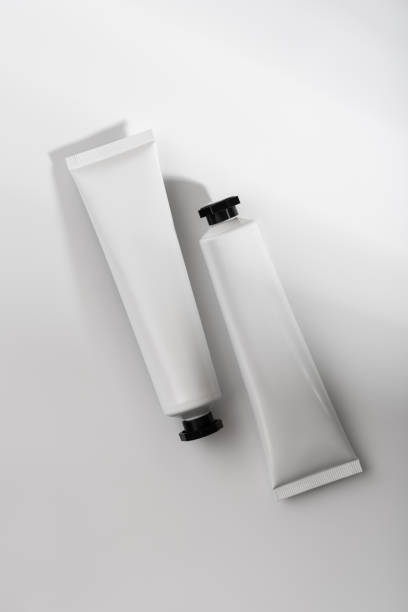 istock Minimalistic composition of two white cosmetic tubes with black caps 2194336328