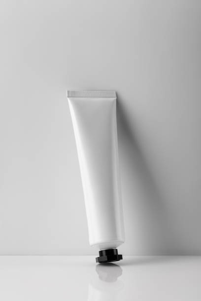 istock Minimalistic composition of white cosmetic tube on a bright surface with soft shadows 2194336381