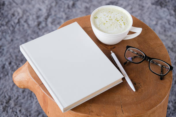 istock blank book mockup on white coffee table with green matcha tea near window 2194337264