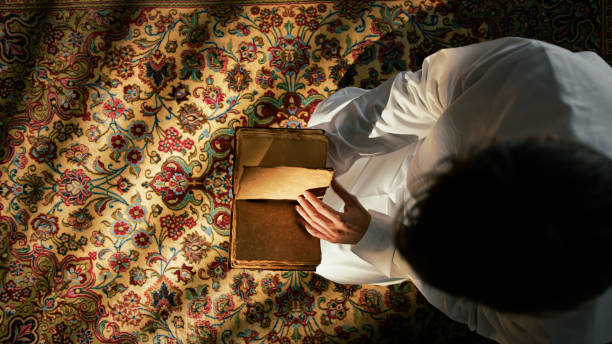 istock Man Praying On Carpet For Ramadan 2194338866