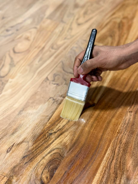 istock Image of unrecognisable person oiling kitchen wooden worktop using paintbrush, counter being painted, sealing and preserving wood, focus on foreground 2194340991