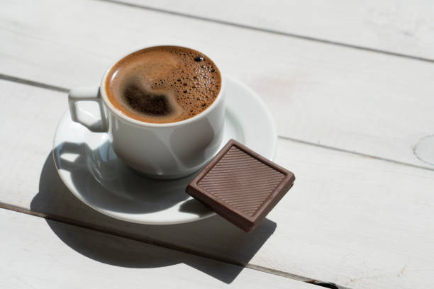 Close up of coffee and chocolate truffles on a restaurant table. Dessert and sweet food concept.