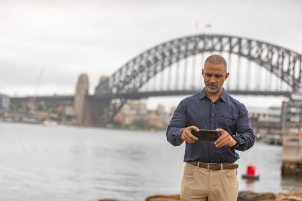 istock Asian Indian Man Taking Photos with the Sydney Harbour Bridge 2194346608