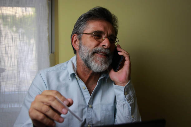 istock Bearded senior man shopping online and using phone 2194347063