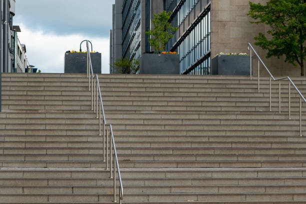 istock Urban steps lead to modern architecture with planters and railings on a cloudy day in a bustling city environment 2194348958