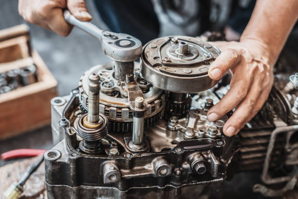 istock Motorcycle mechanic use ratchet wrench and socket  to repair motorcycle engine,working at garage, maintenance and repair motorcycle concept 2194349264