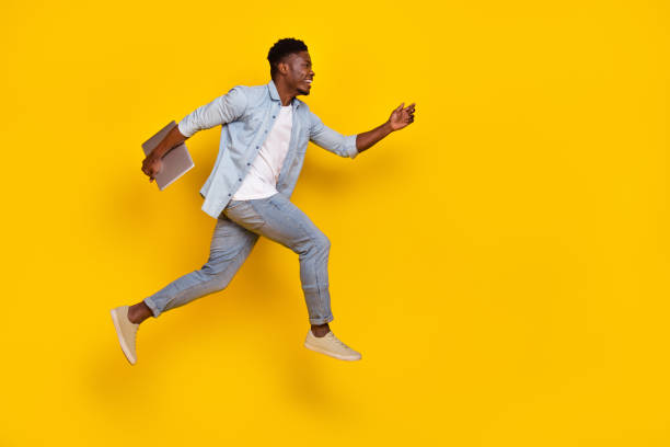 istock Full size profile side photo of guy read netbook discounts jump run quick empty space isolated bright color background 2194349363