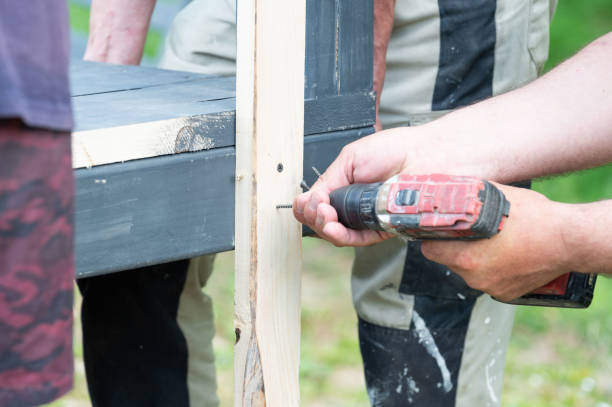 istock Screwing the board with a screwdriver, installing a wooden gazebo. 2194351598