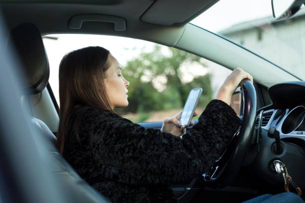 istock Distracted woman talking on her phone while driving. 2194352946