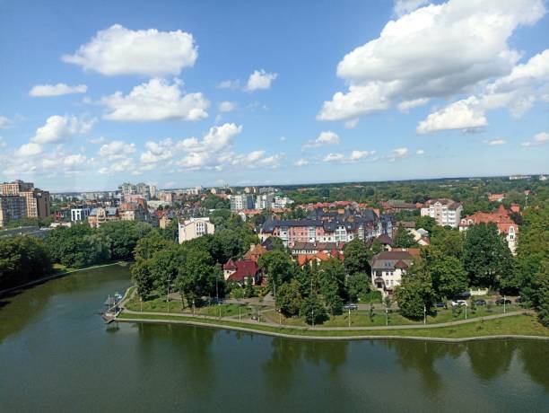 istock cityscape from above, small lake surrounded by green trees 2194354441