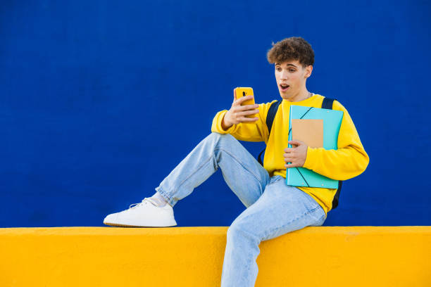 istock Surprised college student reading news on smartphone 2194354858