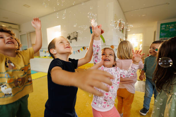 istock Children having fun playing whit soap bubbles indoors 2194355285