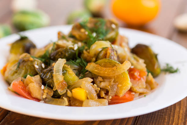 istock Brussel sprouts cooked with vegetables, on a wooden table 2194355529