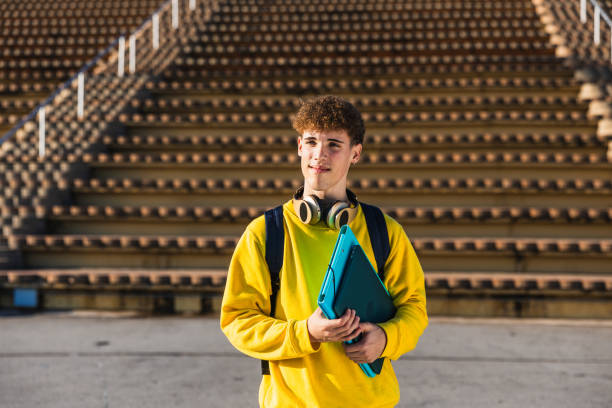 istock Smiling college student holding books and looking away 2194355909